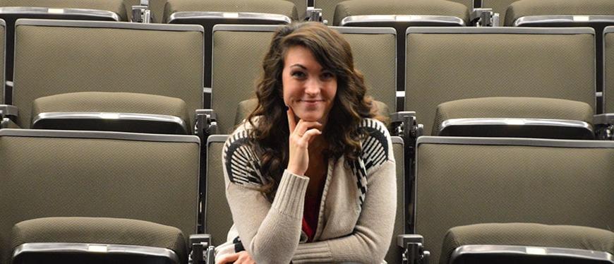 Female student sitting in the East Campus theatre